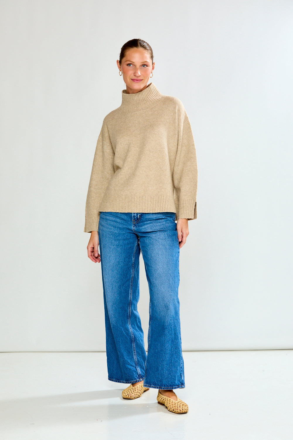 Woman in oat sweater with jeans