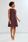 Woman wearing a brown dress against a white background
