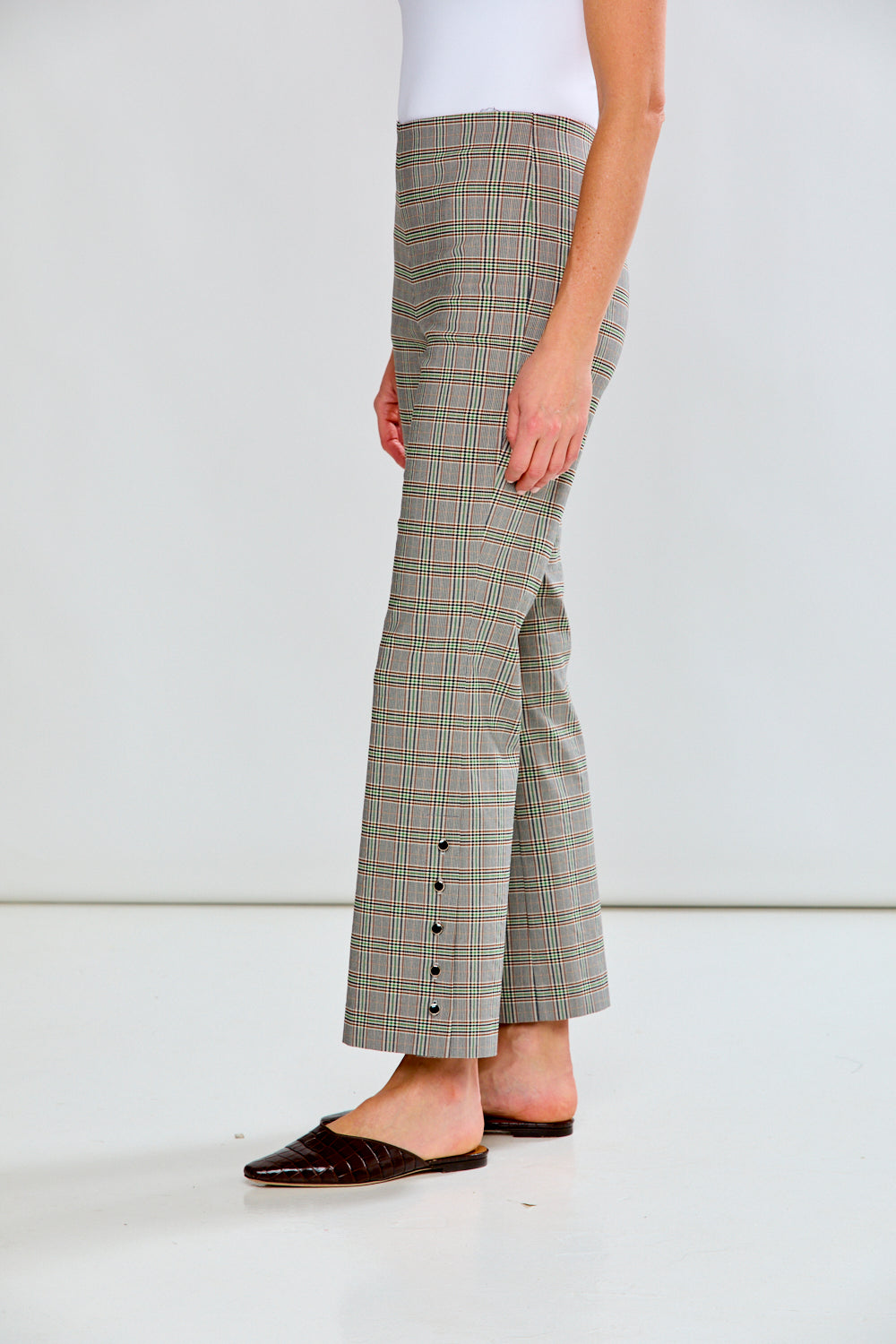 Person wearing plaid pants on a white background