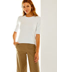 Woman in white short sleeve sweater