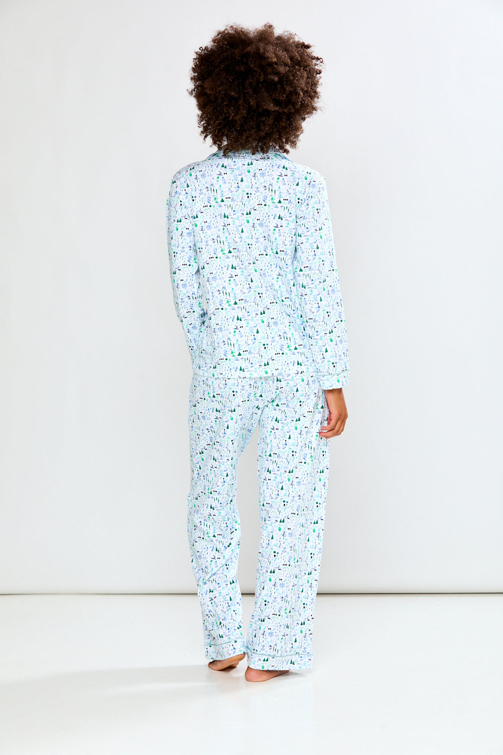 Woman wearing a light blue pajama set on a white background
