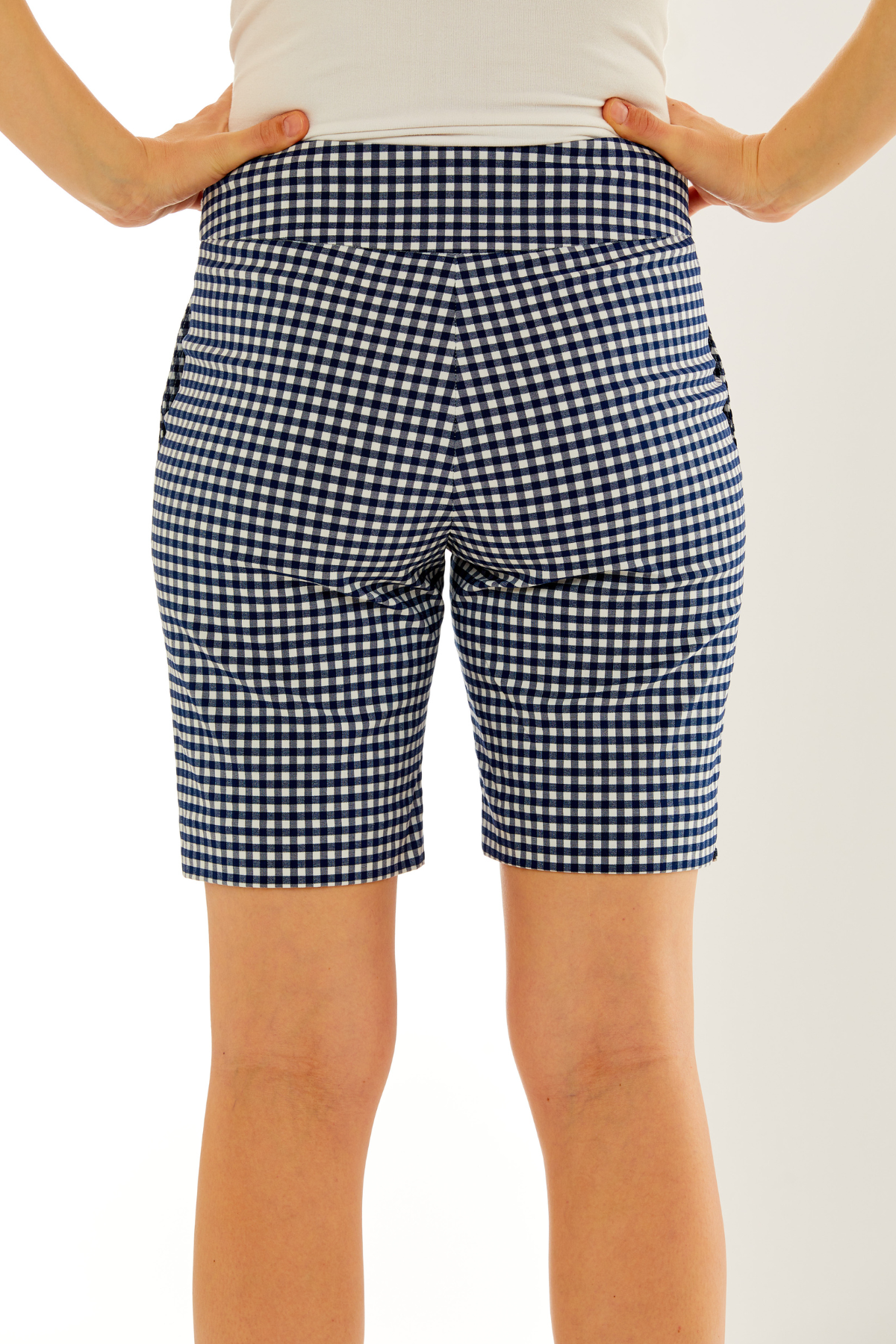 Woman in navy and white gingham short