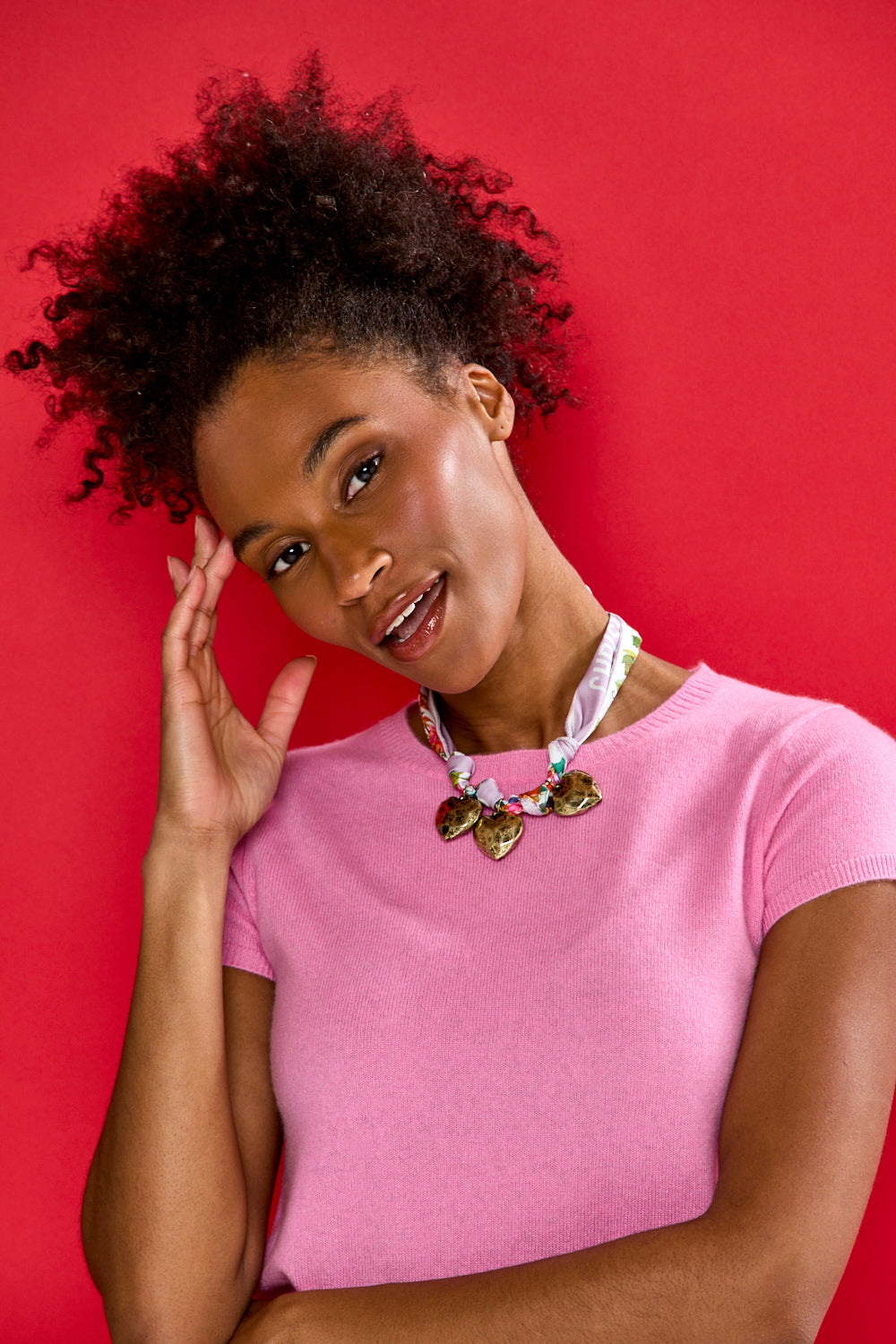 Woman wearing a pink shirt with a red background