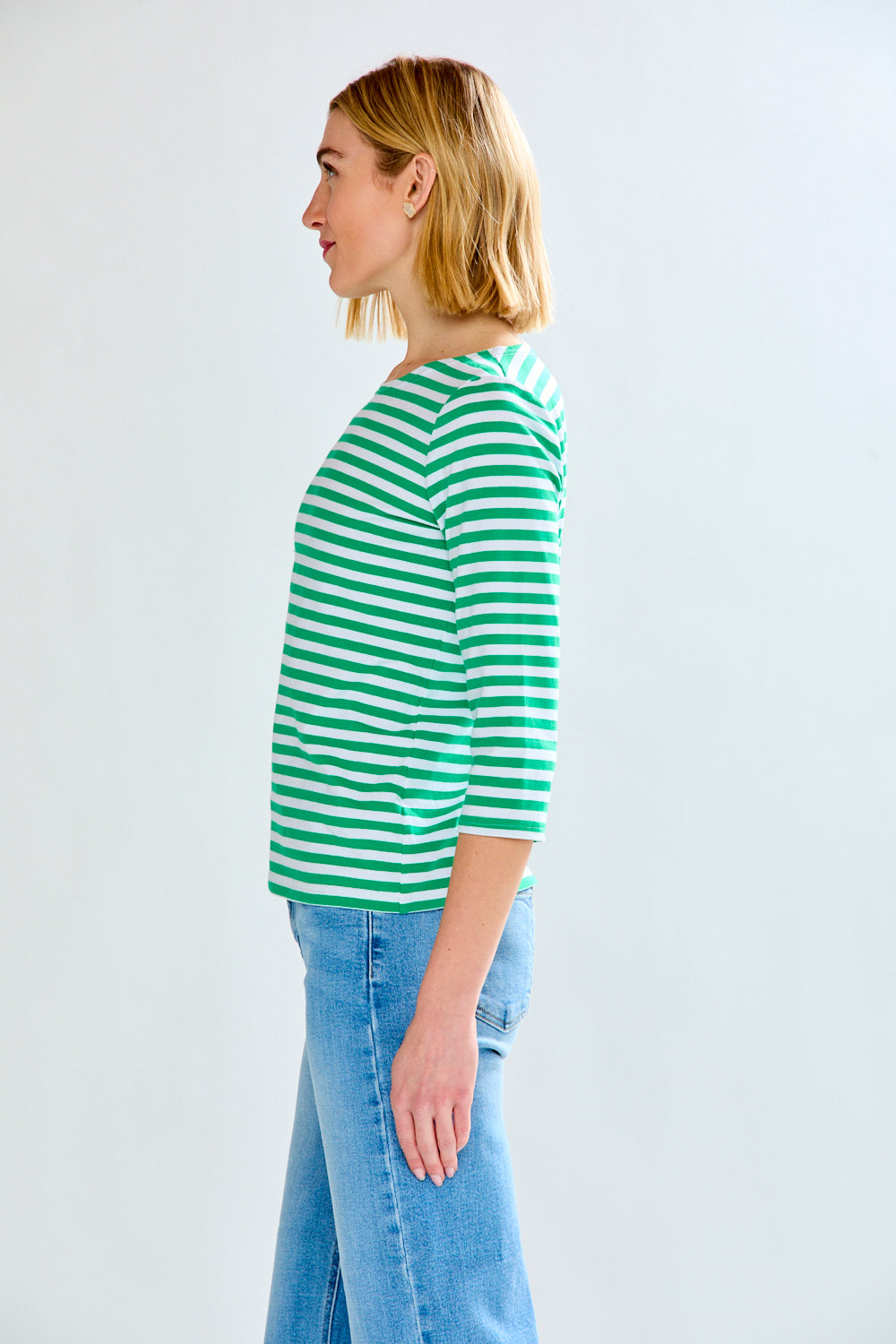 Woman in green/white stripe knit top