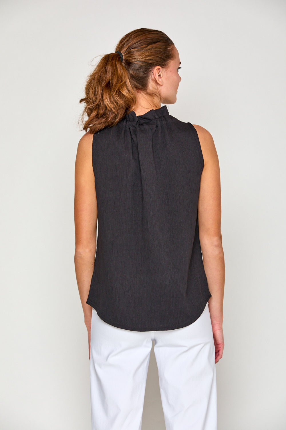 Woman in black sleeveless blouse