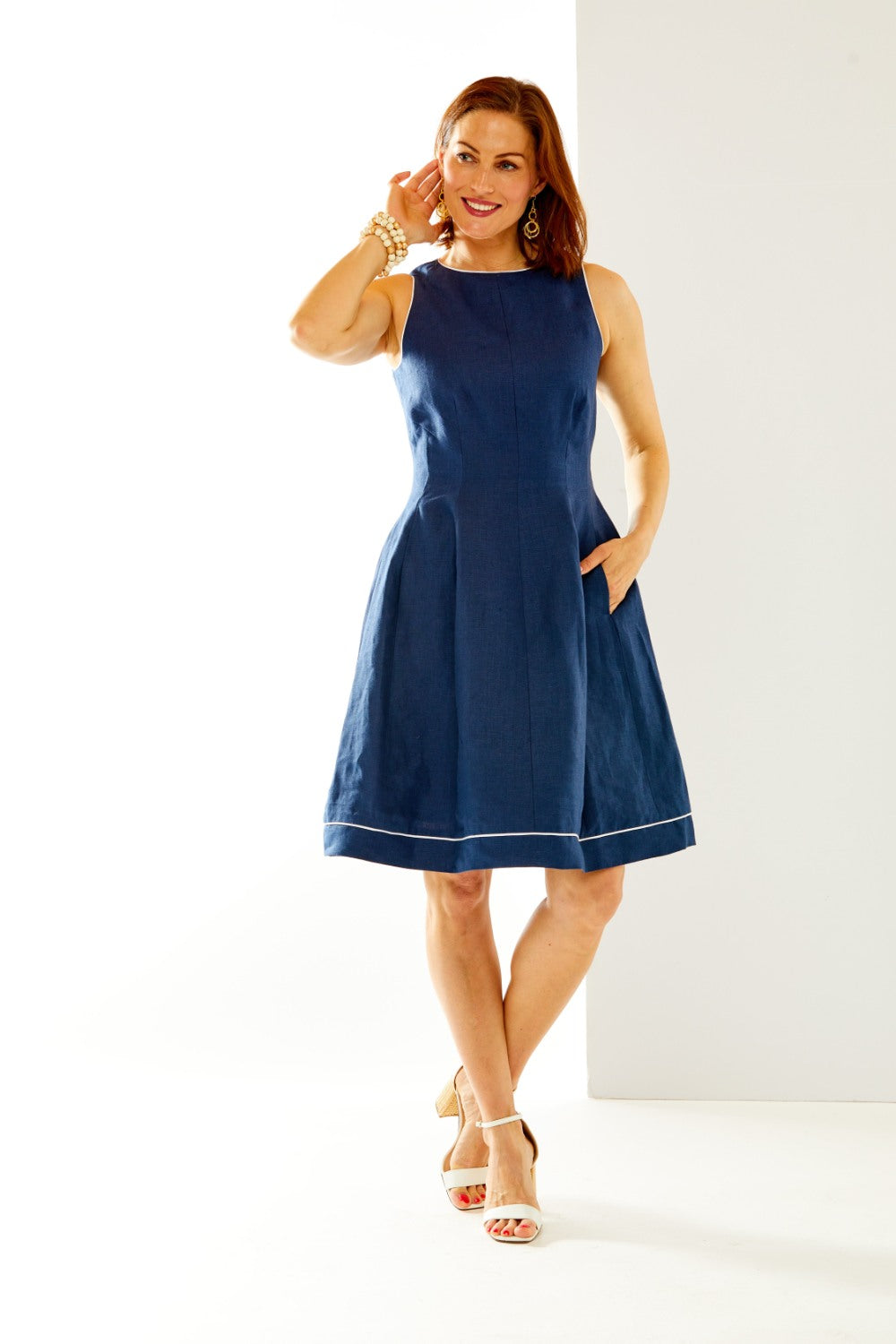 Woman in navy dress with white piping