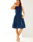 Woman in navy dress with white piping