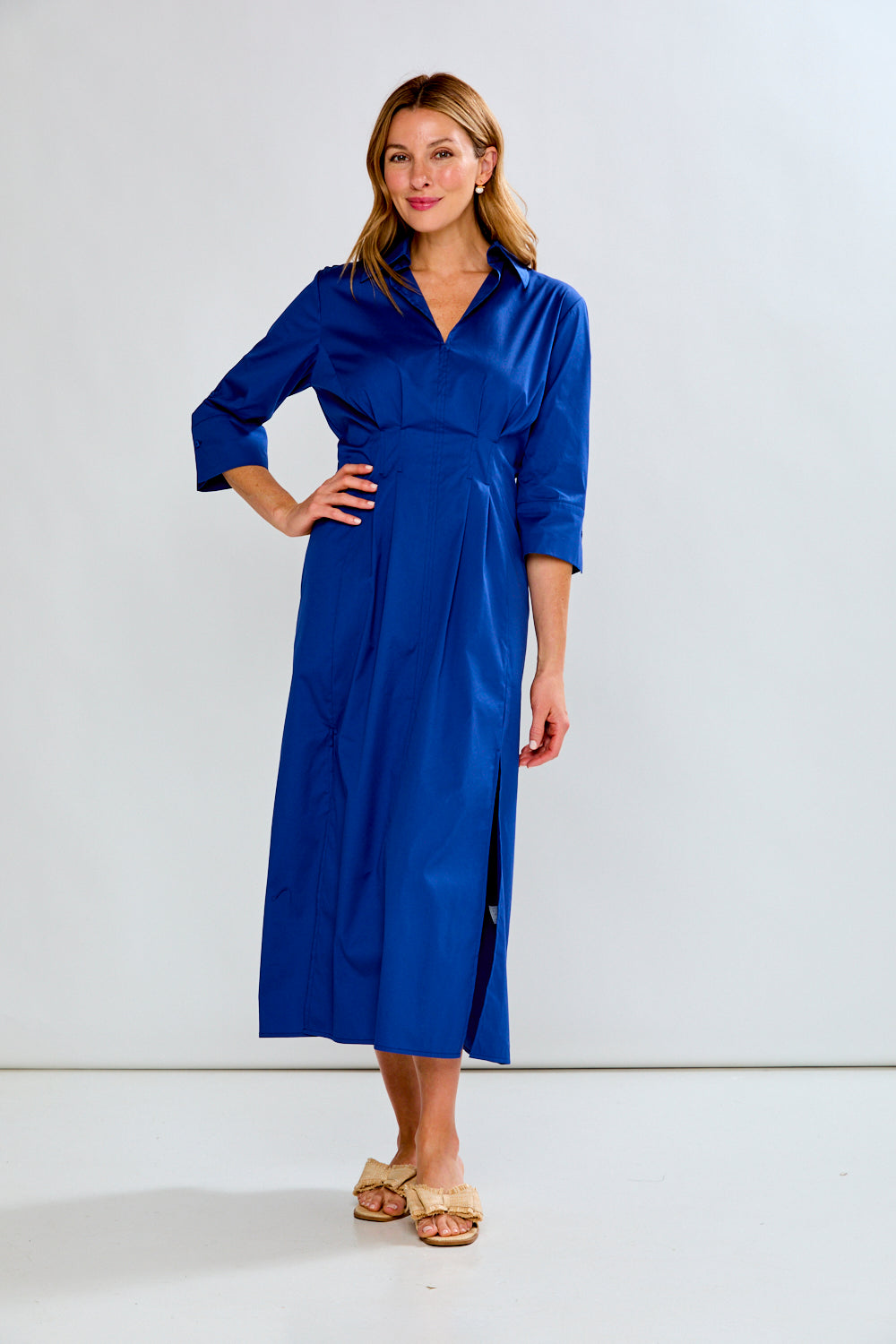 Woman wearing a blue dress against a white background