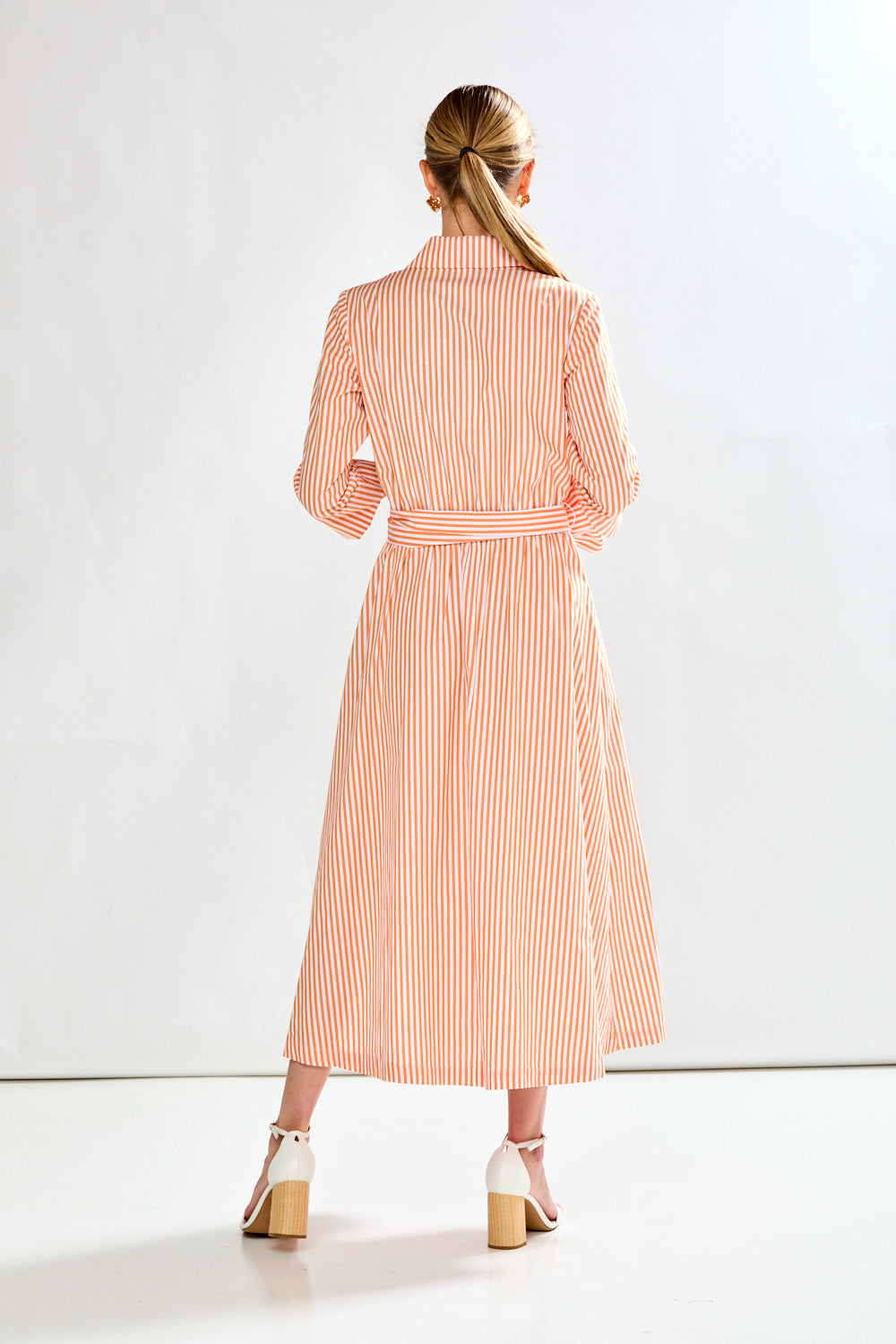 Woman in orange stripe dress