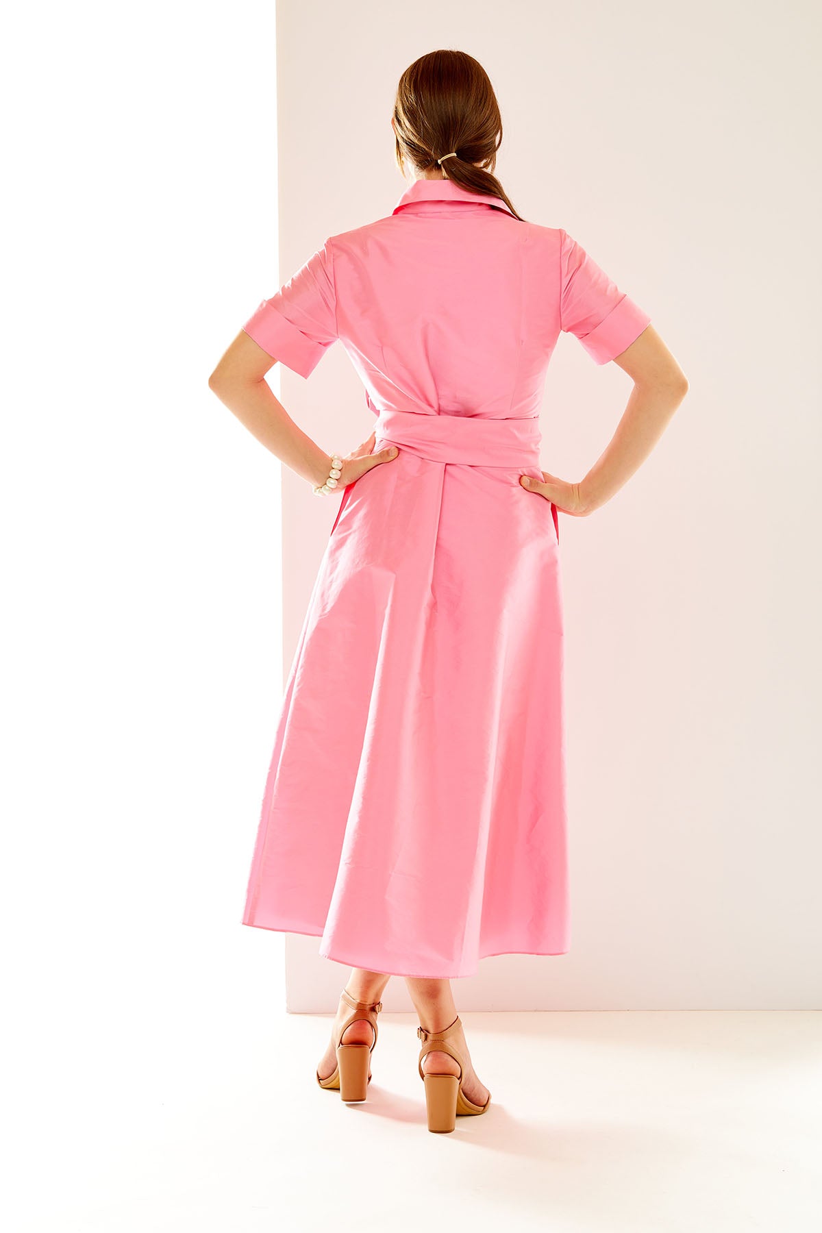 Woman in bubblegum pink midi dress