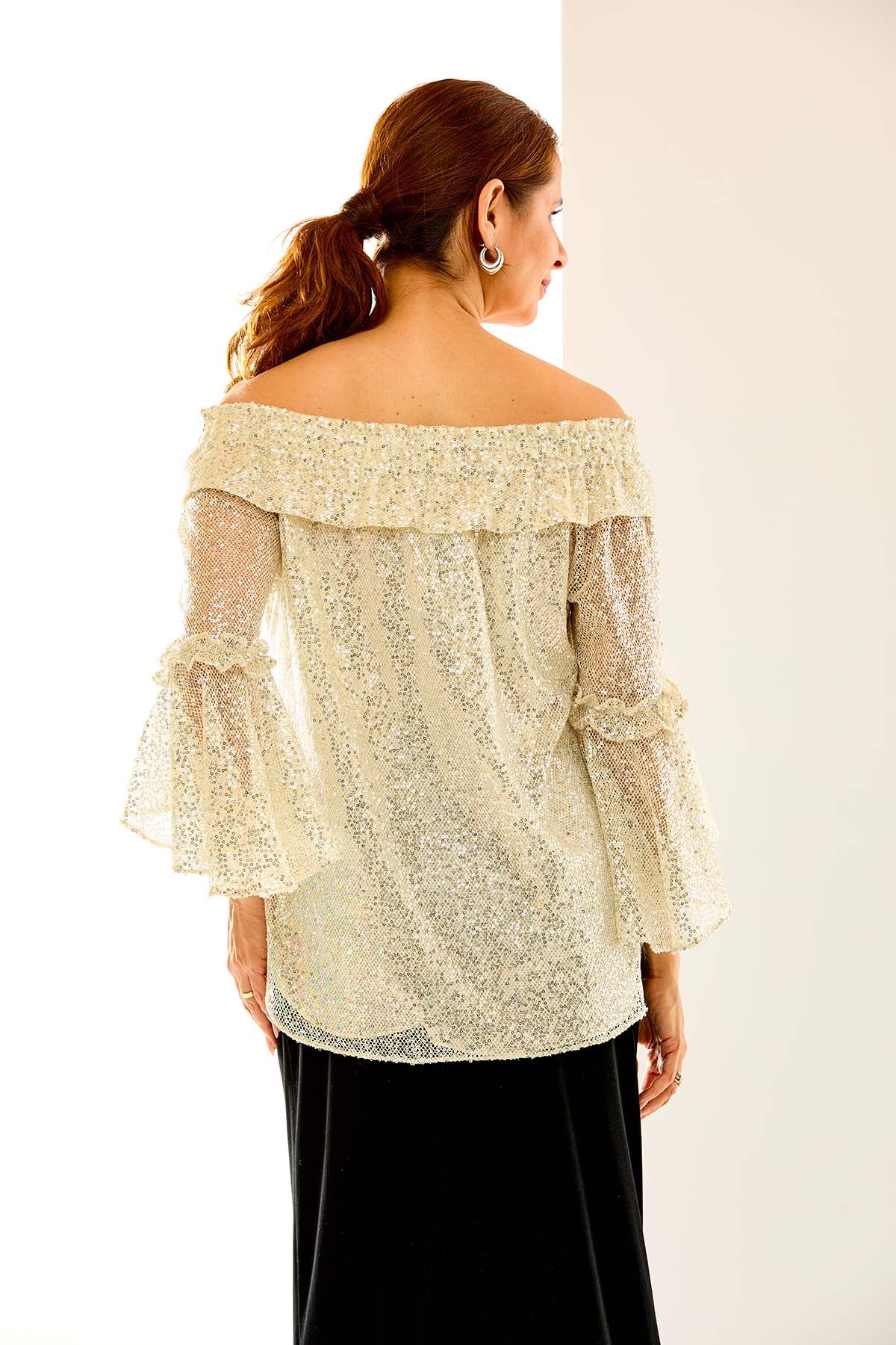 Woman in sequin mo blouse