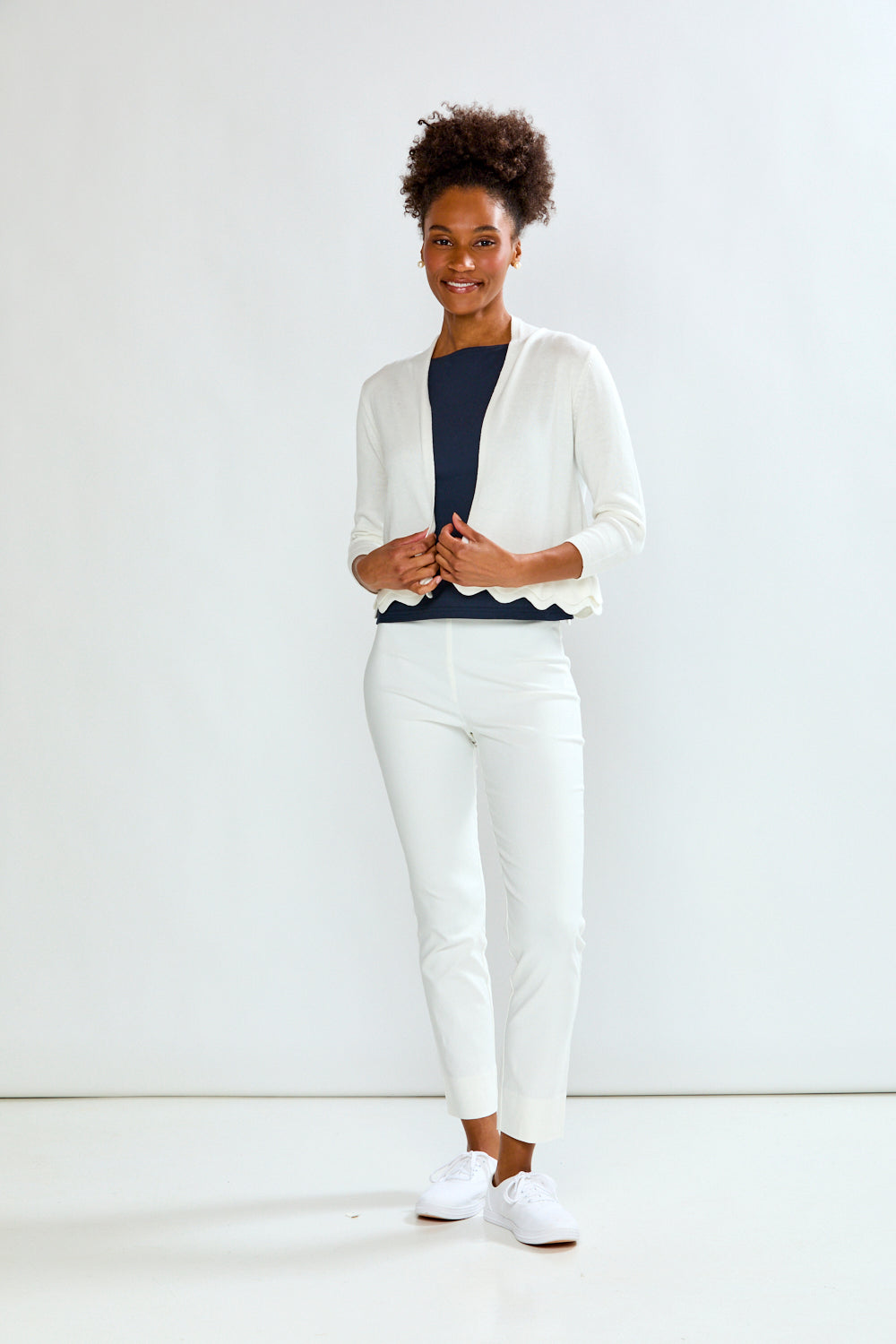 woman in white scalloped sweater