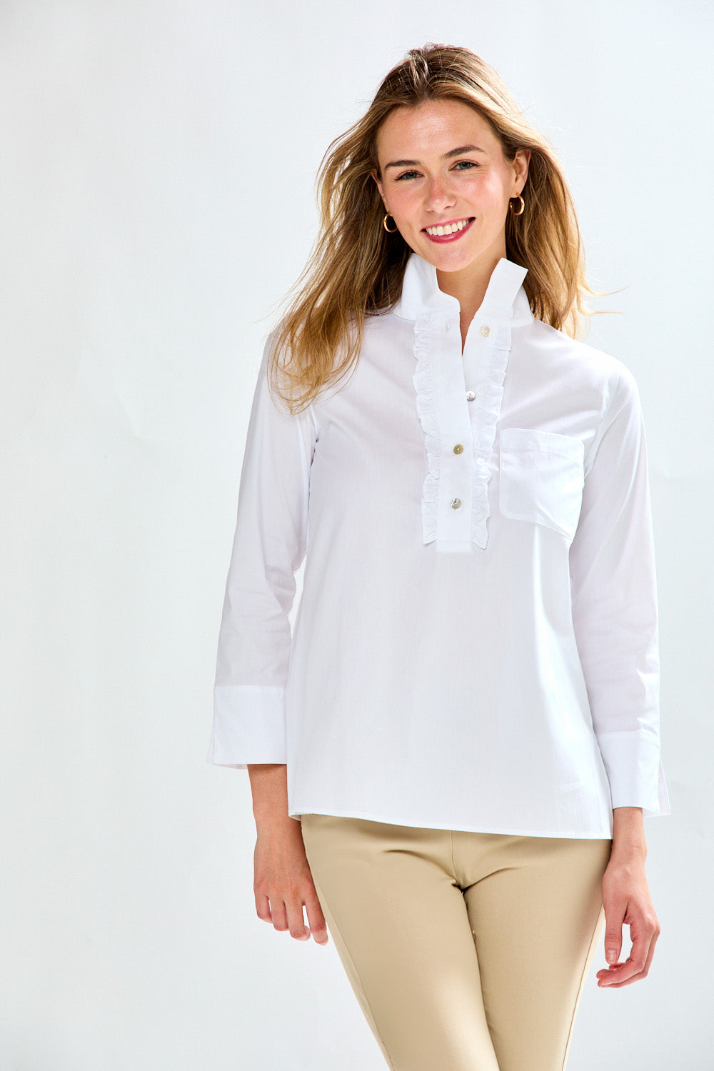 Woman in white blouse with ruffle