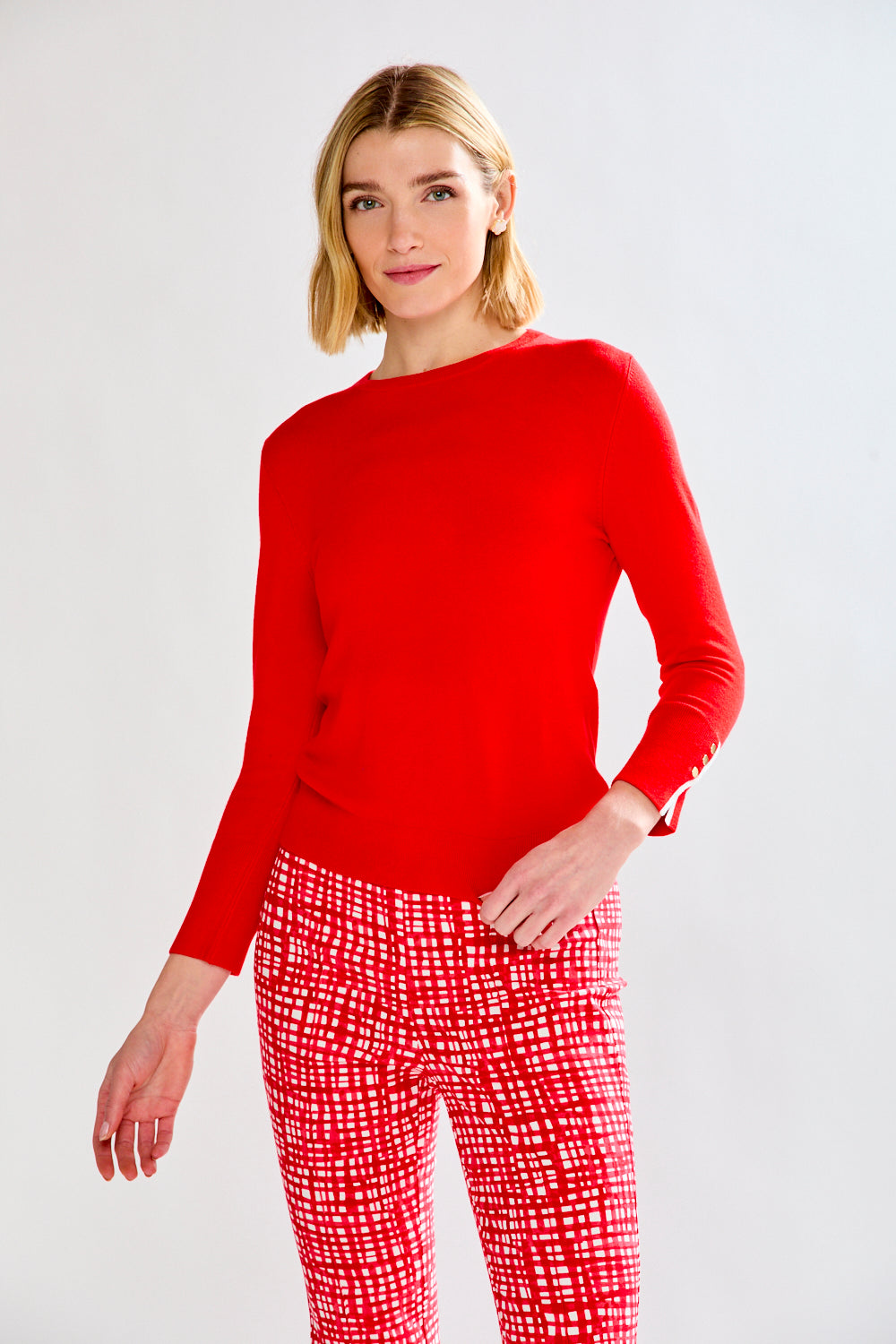 woman in red sweater and patterned pants
