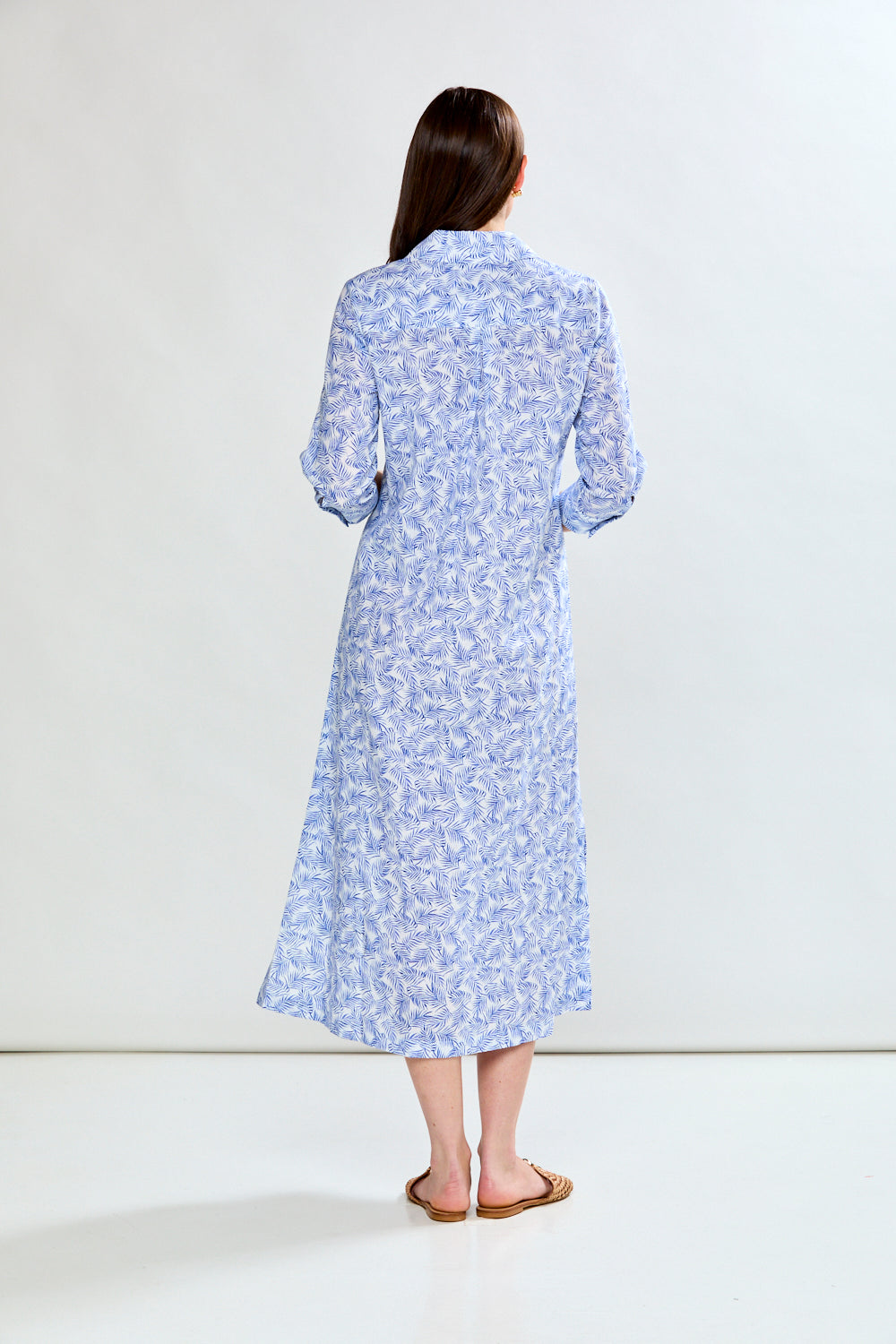 Woman in blue tropical leaf dress