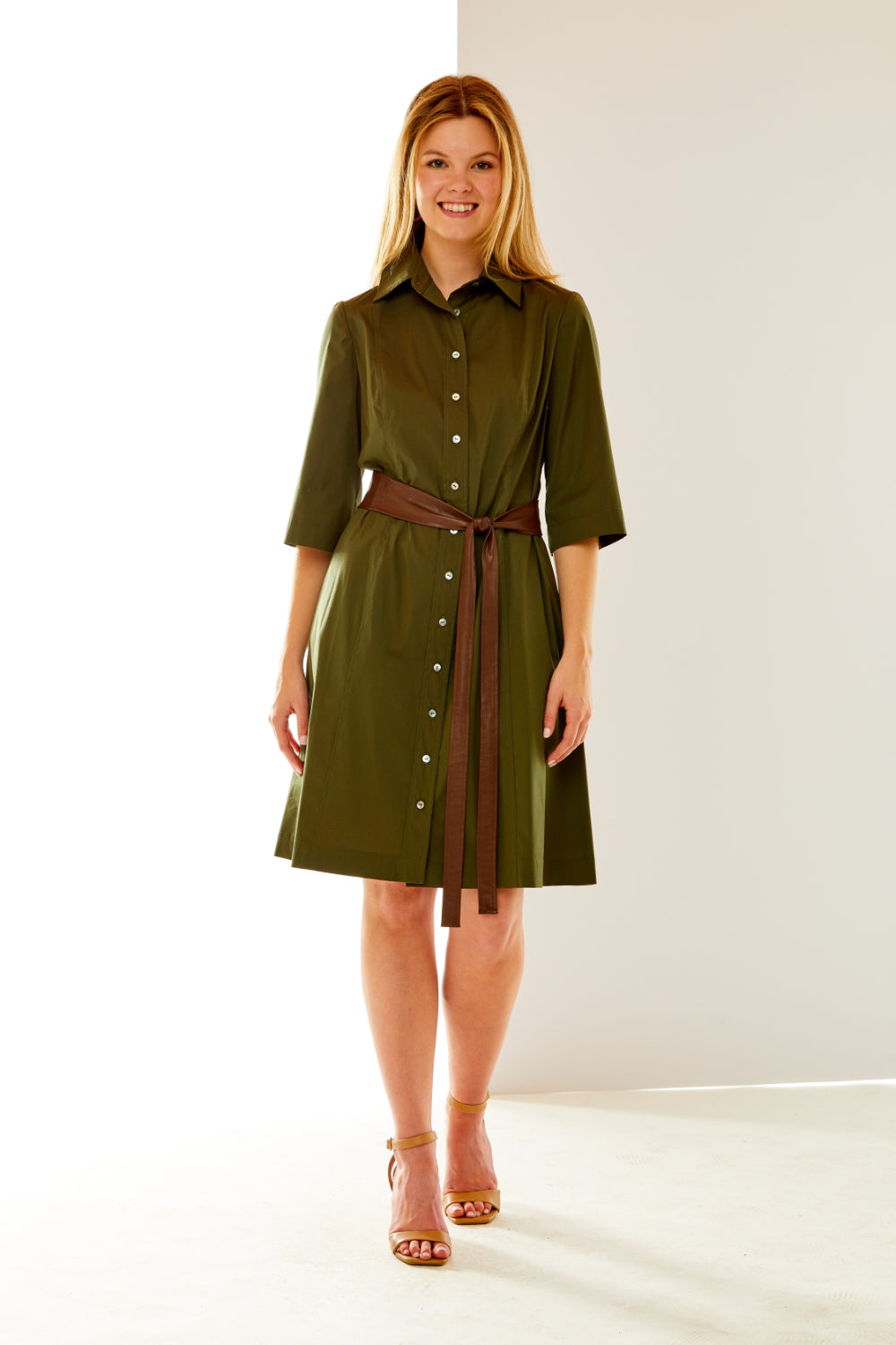 Woman in olive dress with faux leather sash