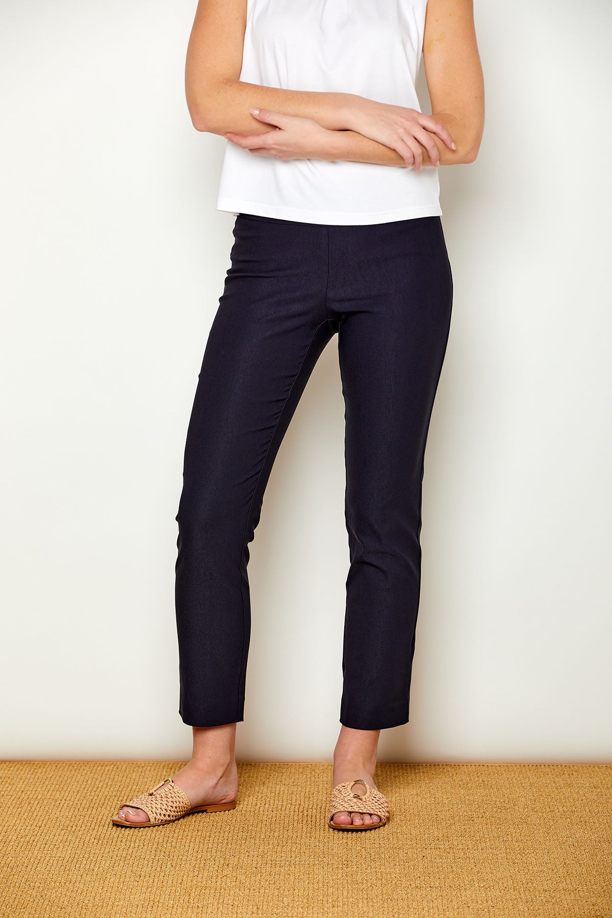 Woman in fitted navy colored pants