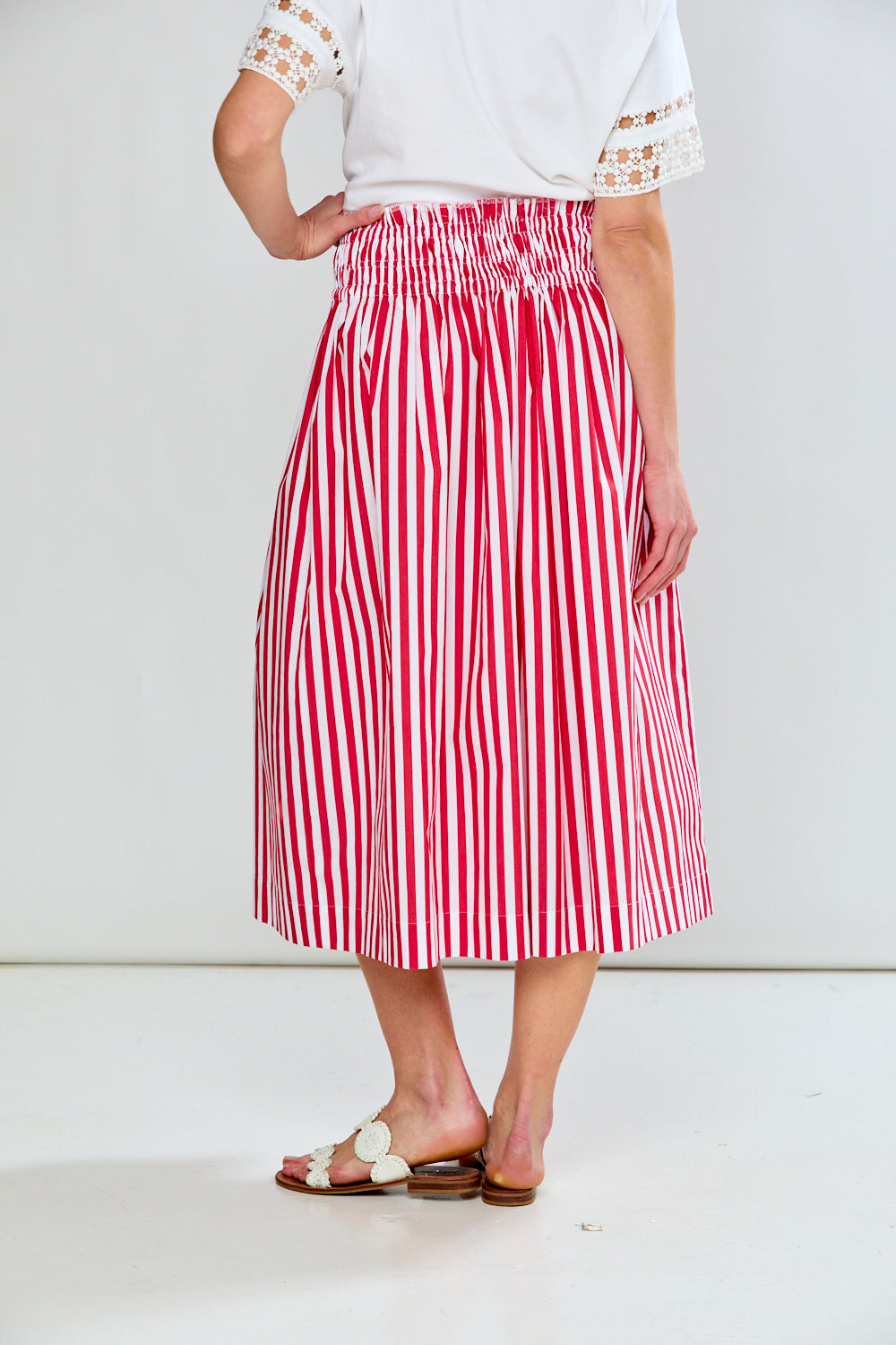 Woman in red & white stripe skirt