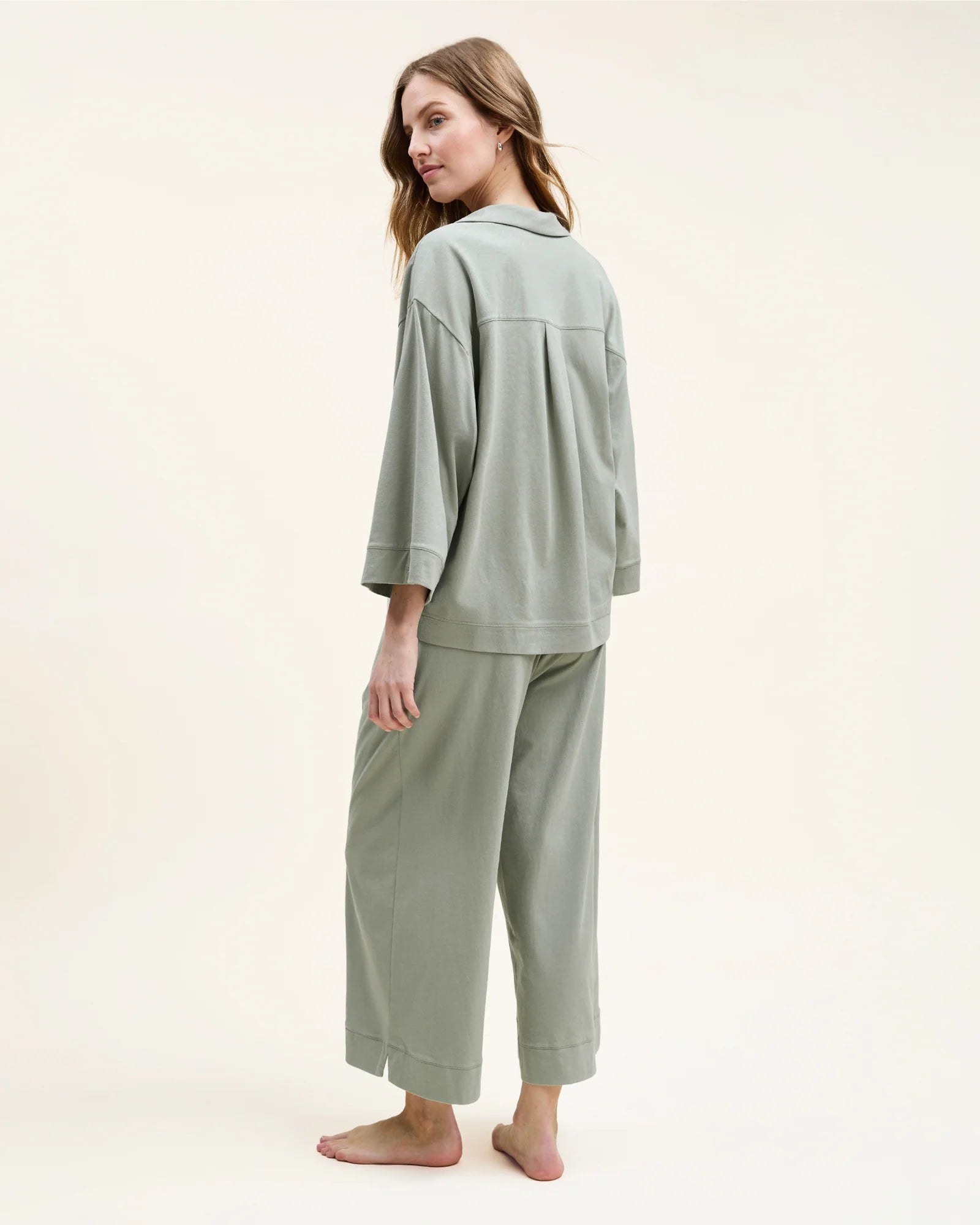 Woman in sage green pajamas