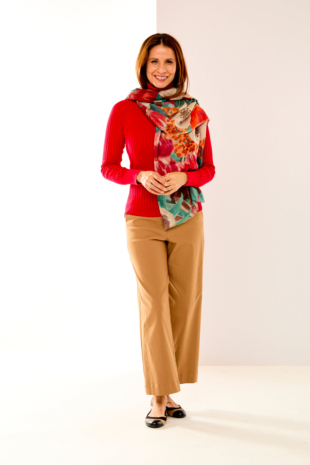 Woman in floral teal and orange scarf