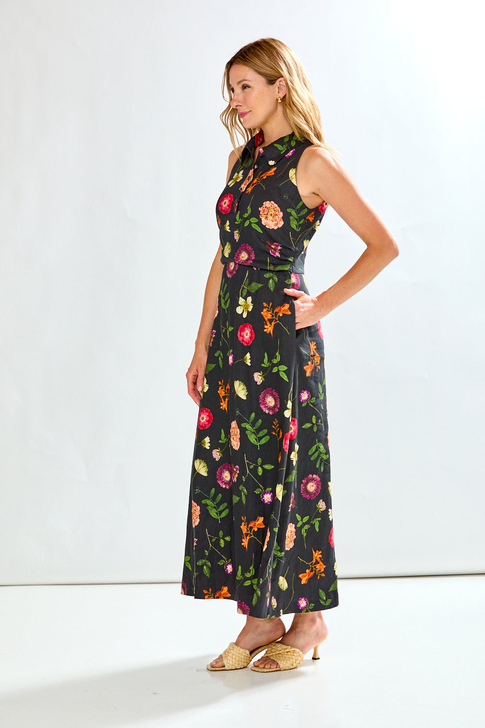 Woman in black linen dress with multi colored flowers