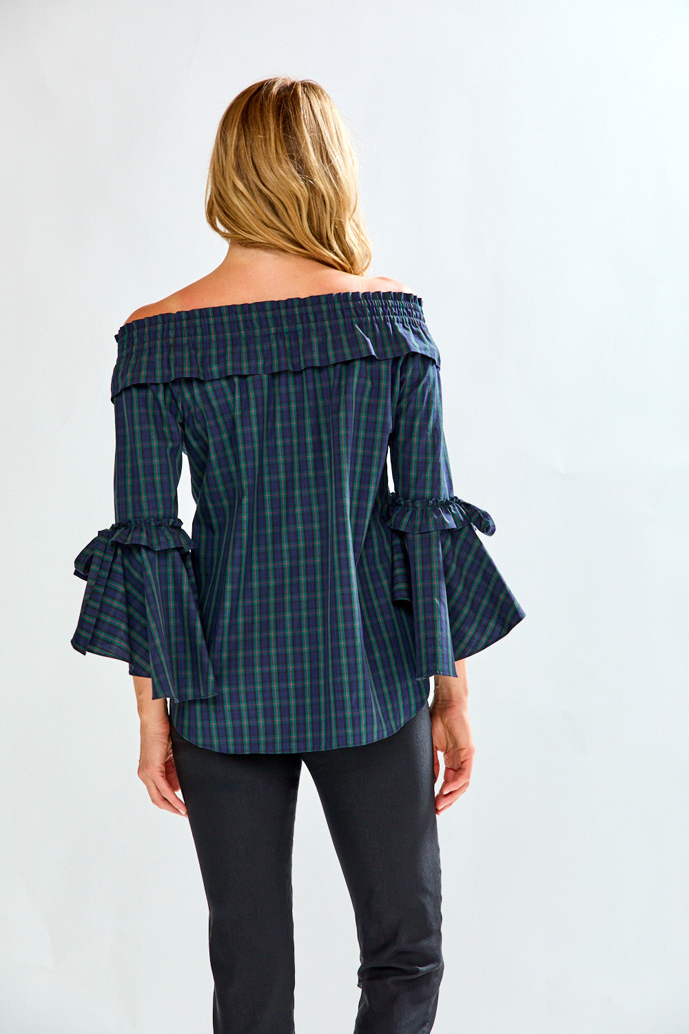 Woman in plaid on/off shoulder top