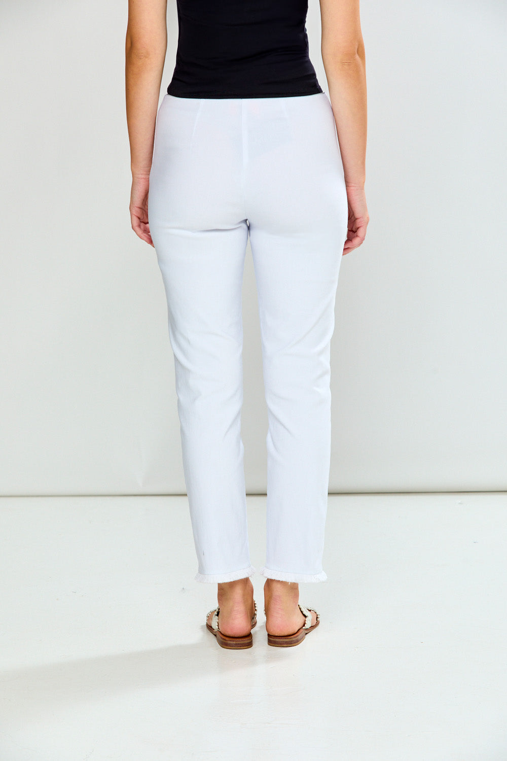 Woman wearing white pants on a white background