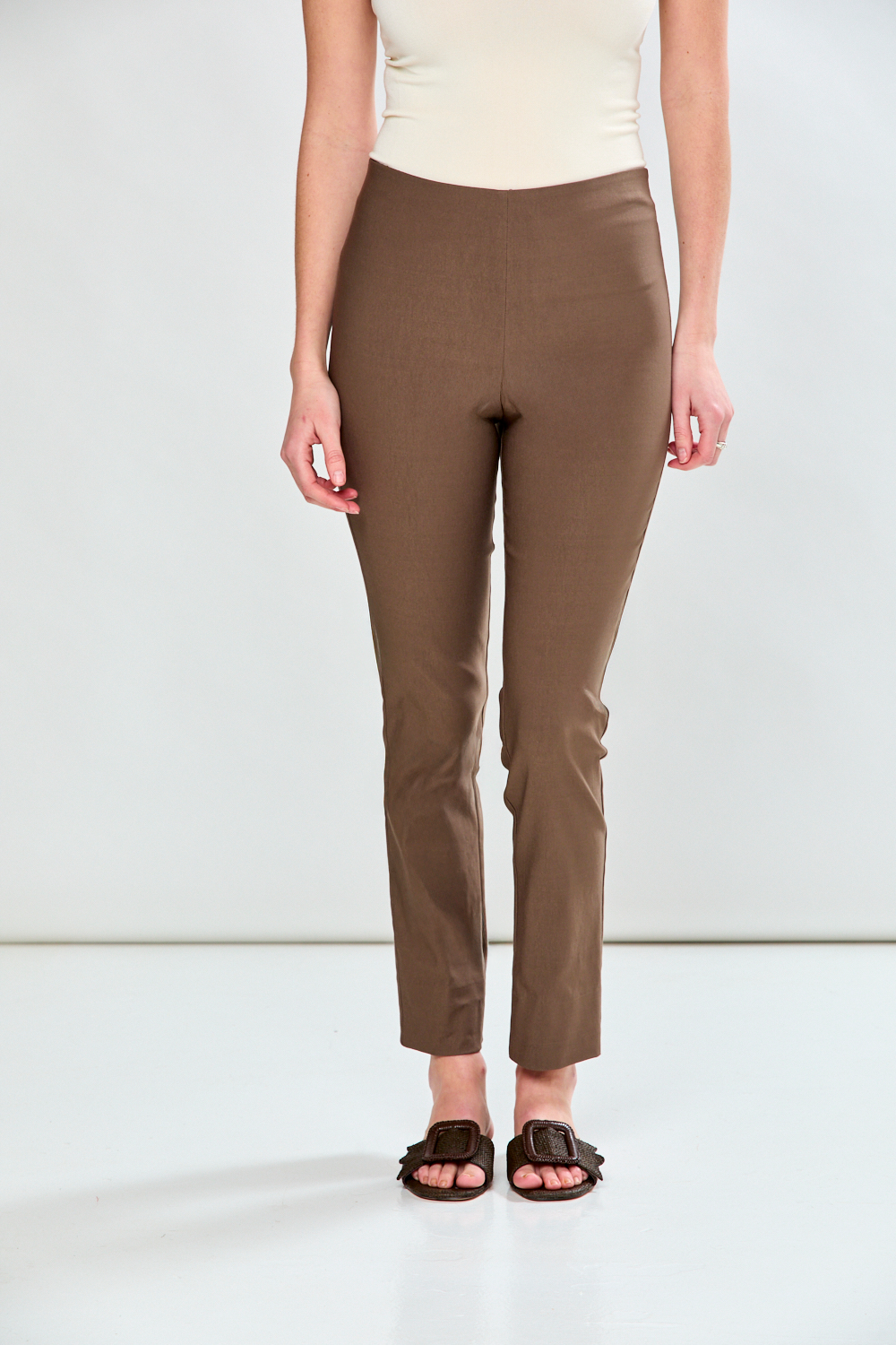 Person wearing brown pants on a white background