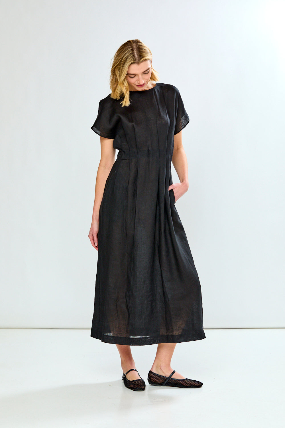 Woman wearing a black dress against a white background