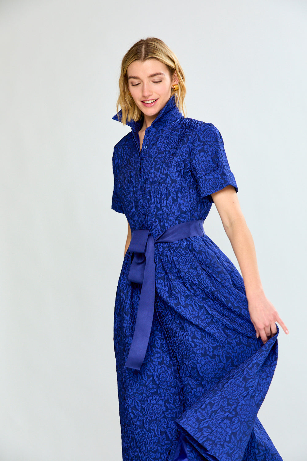 Woman in blue dress with bow