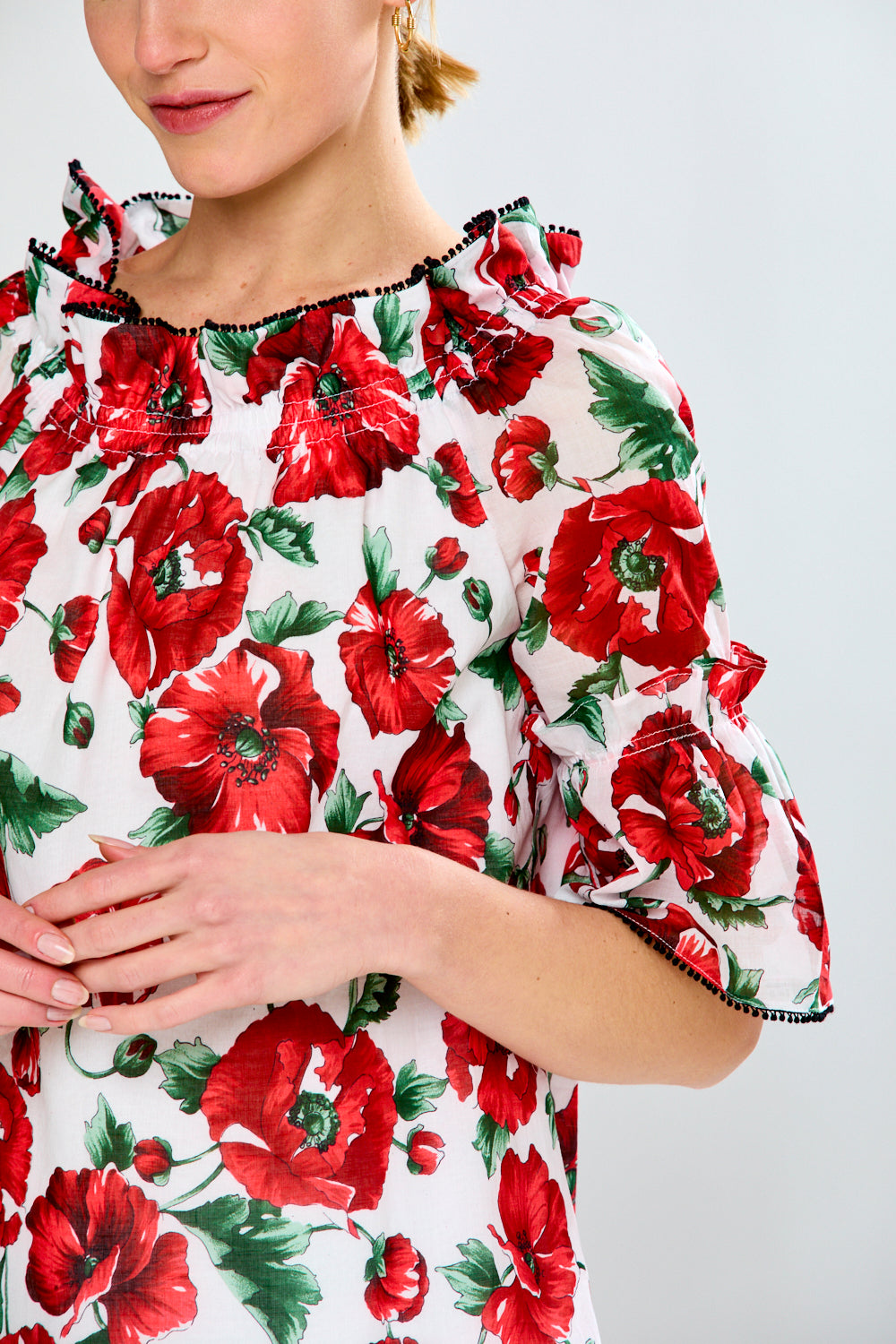 Women in floral red top with black trim