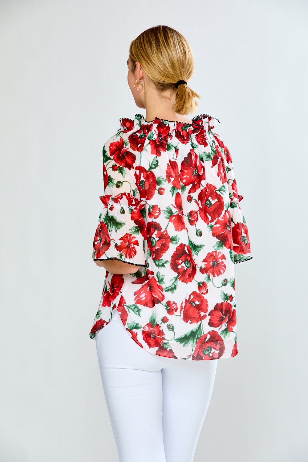 Women in floral red top with black trim