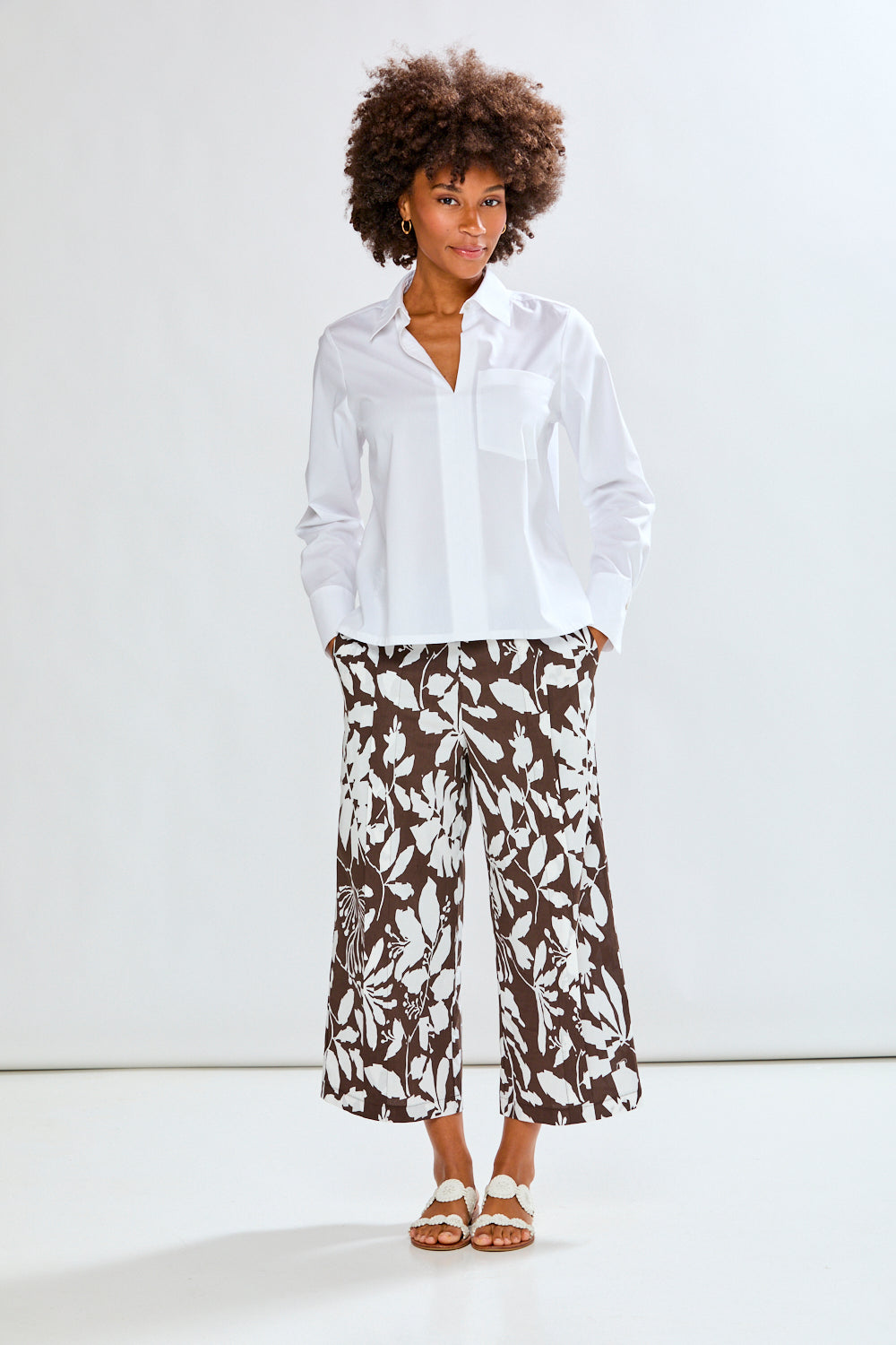 Woman wearing patterned pants with a white background
