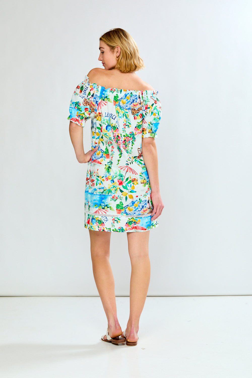 Woman in off the shoulder costal dress