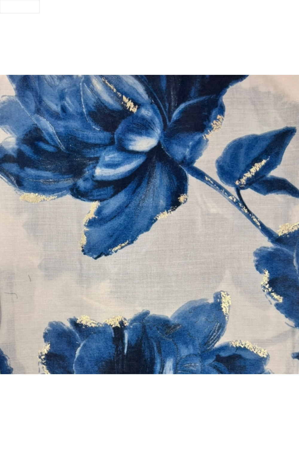 Close-up of a floral design with blue flowers and gold accents on a light background