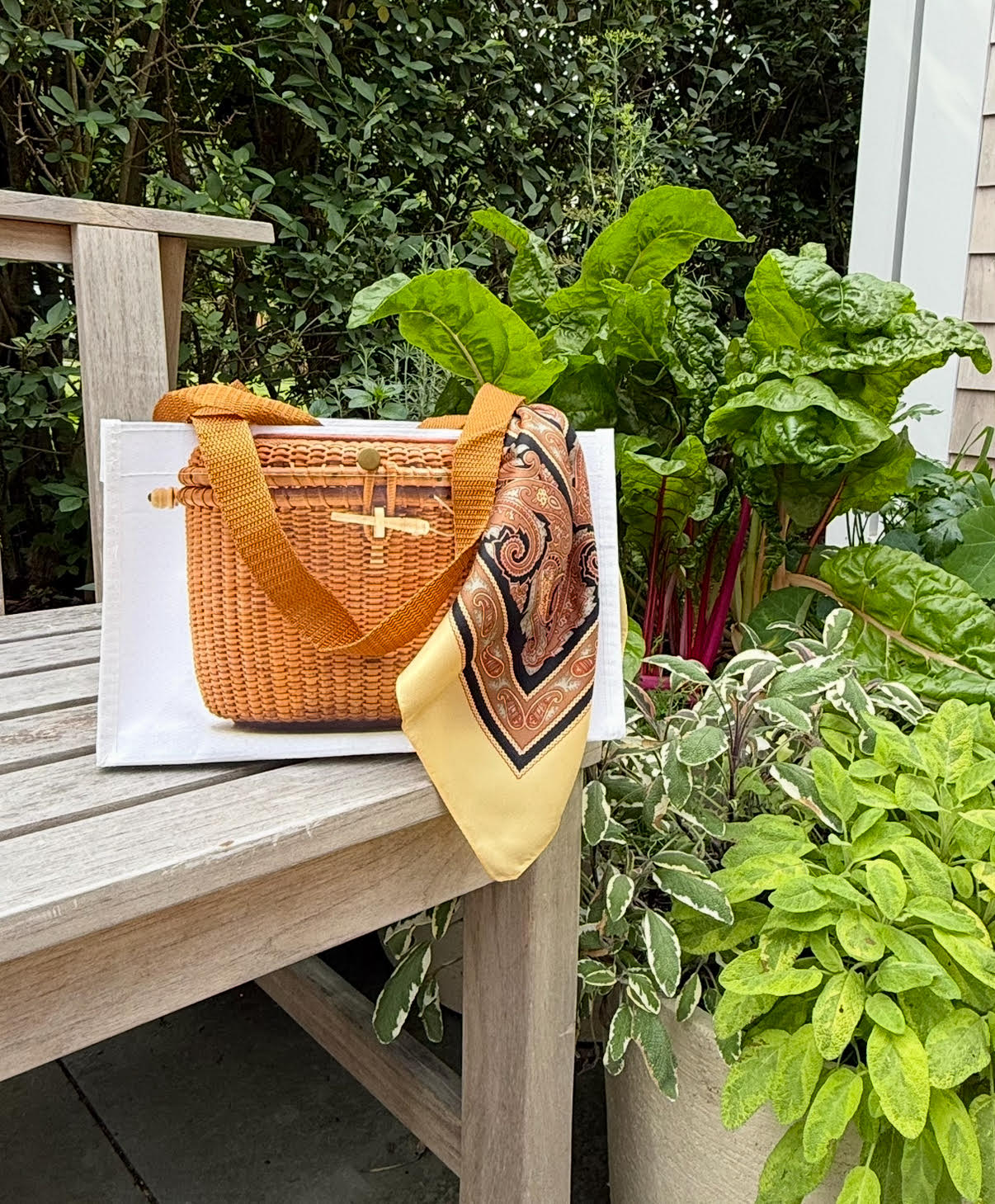 Wicker handbag with a textured white bag on a white background