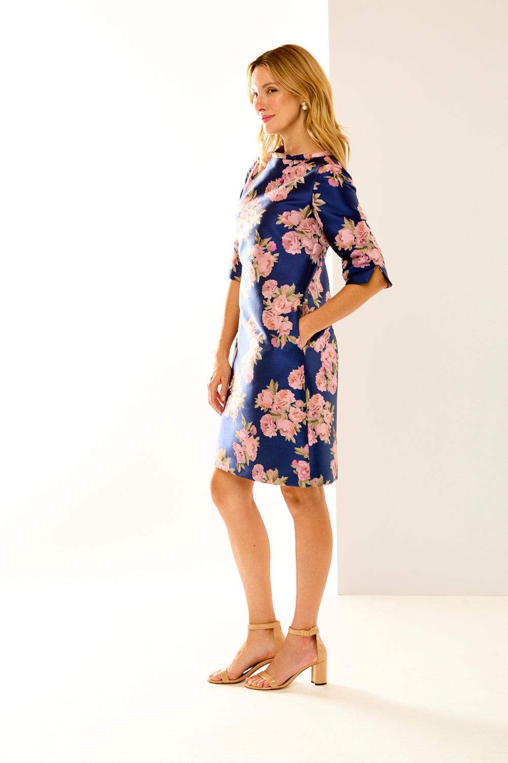 Woman in navy roses dress