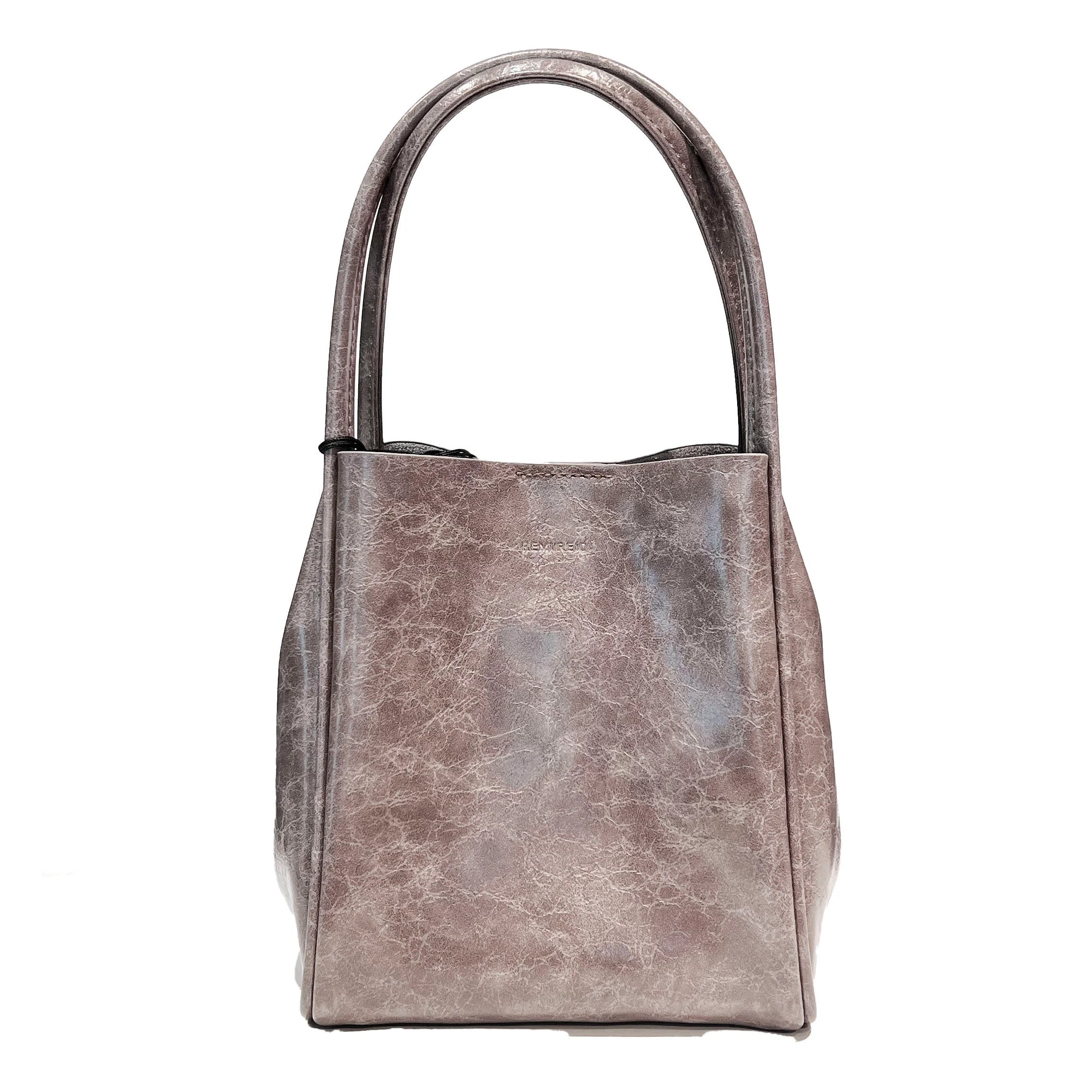A brown waxed tote handbag with a structured design and dual handles.