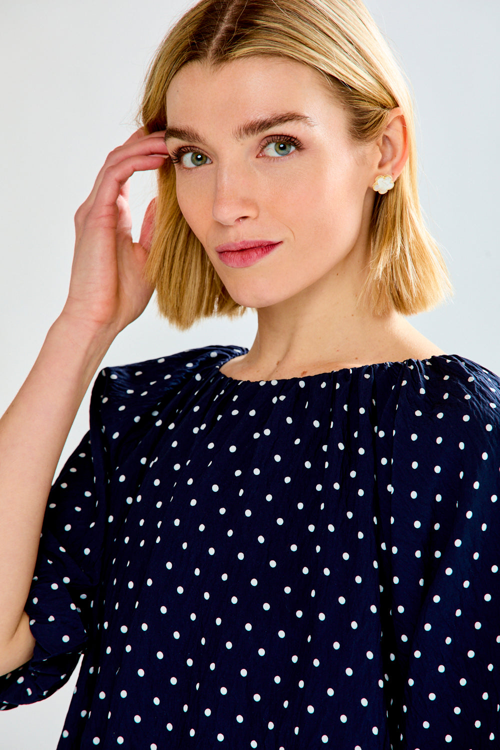 woman with polkadot shirt and jeans