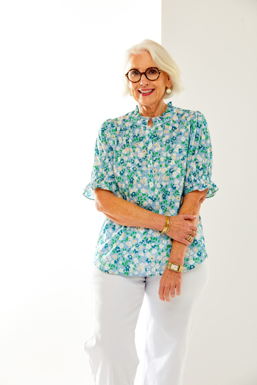 Woman in floral blouse with ruffle sleeve