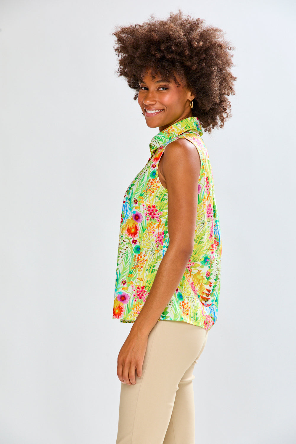 Woman in floral shirt and tan pants 