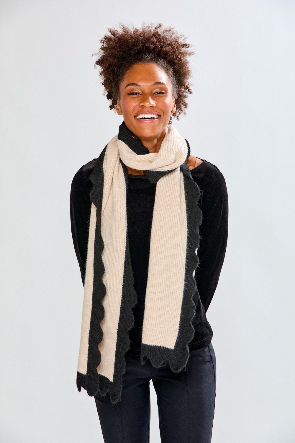 Woman wearing a beige scarf against a white background