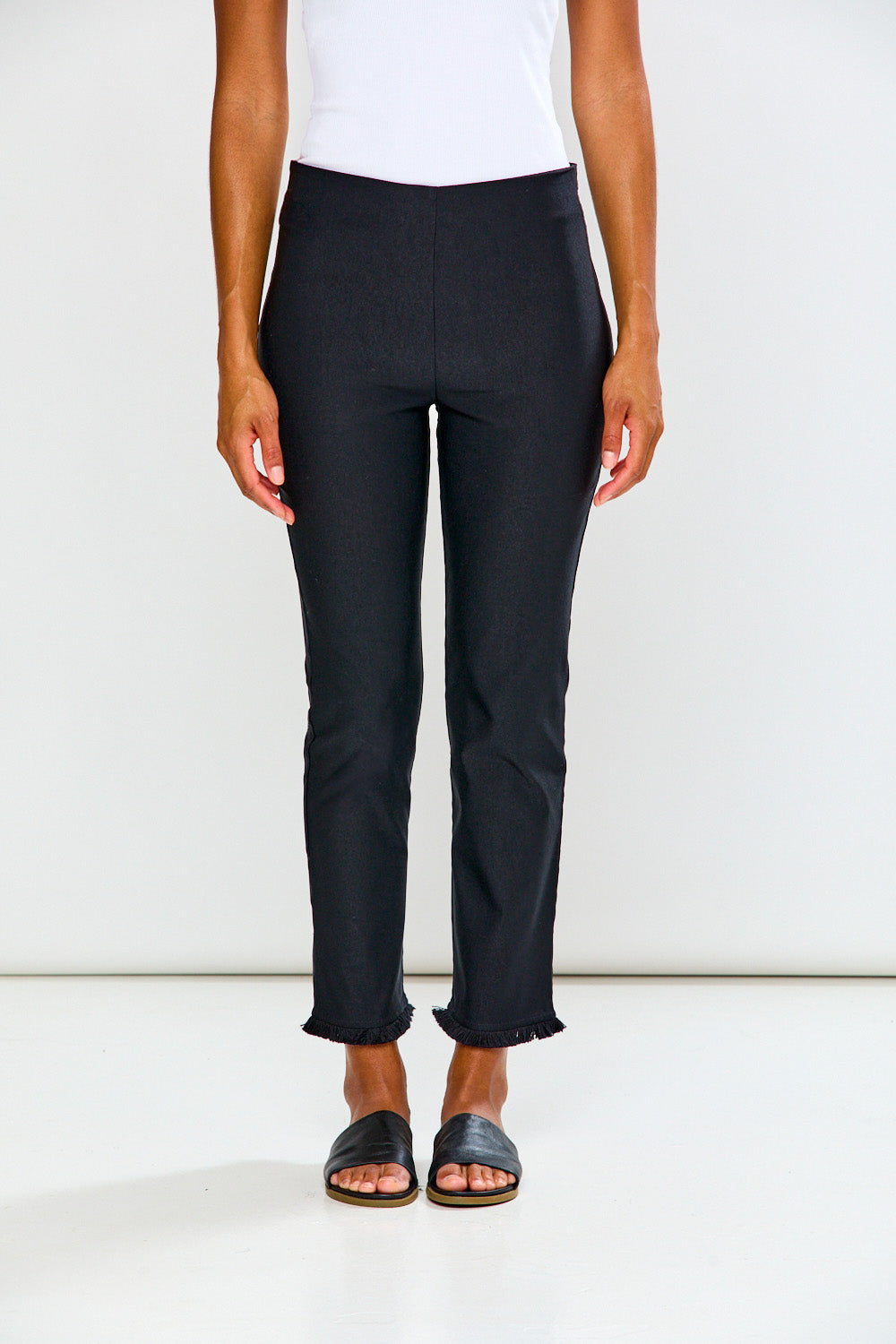 Woman wearing black pants on a white background