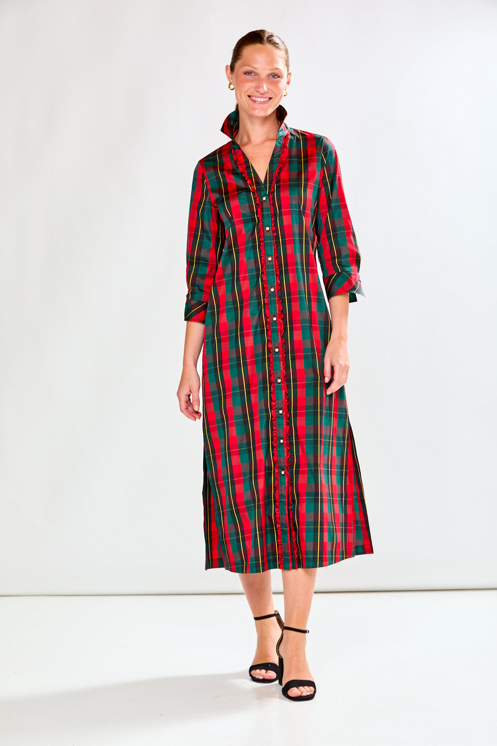Woman wearing a red and green plaid dress on a white background