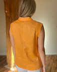 Woman in tangerine sleeveless linen top