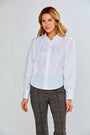 Woman in white blouse with patterned pants 