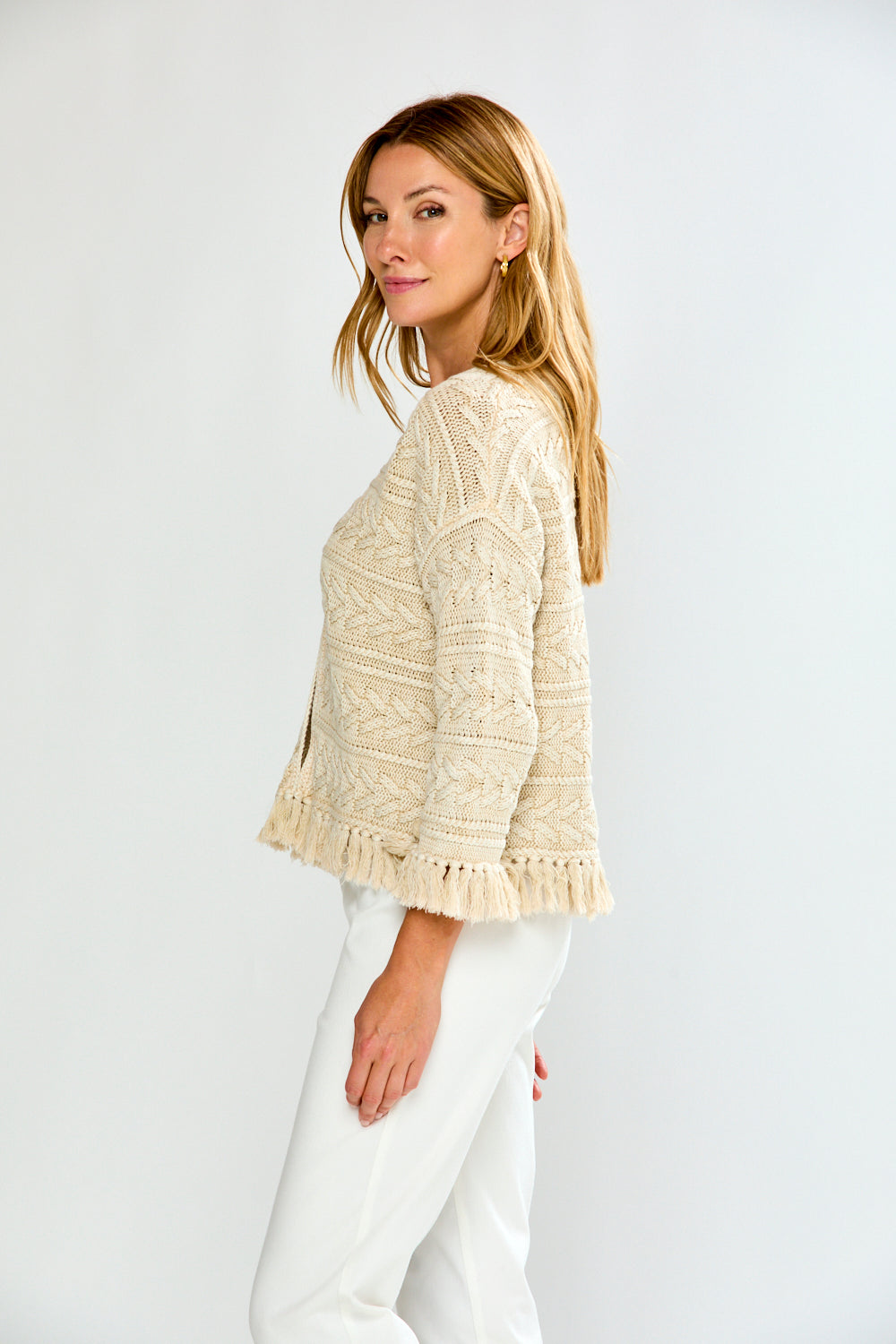 Woman in pebble cardigan with white pants