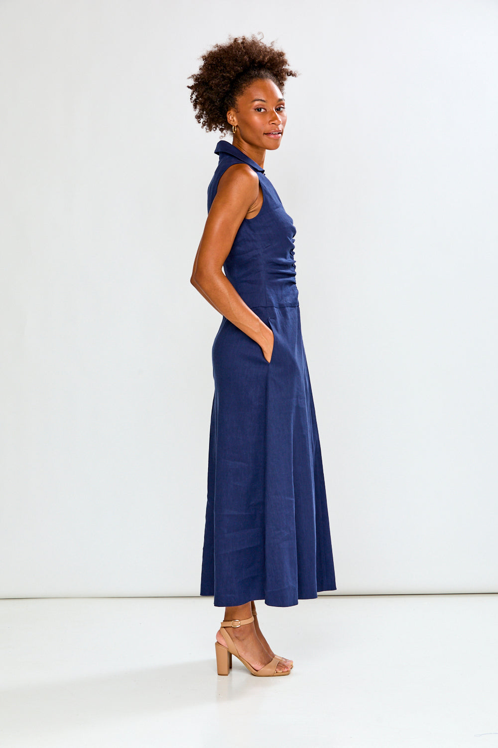 Woman wearing a blue dress against a white background