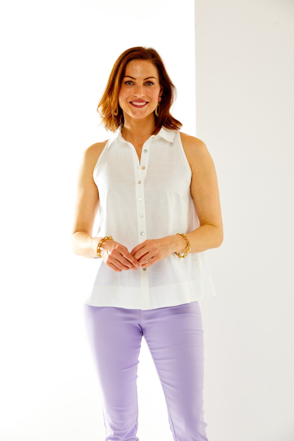Woman in sleeveless button down top