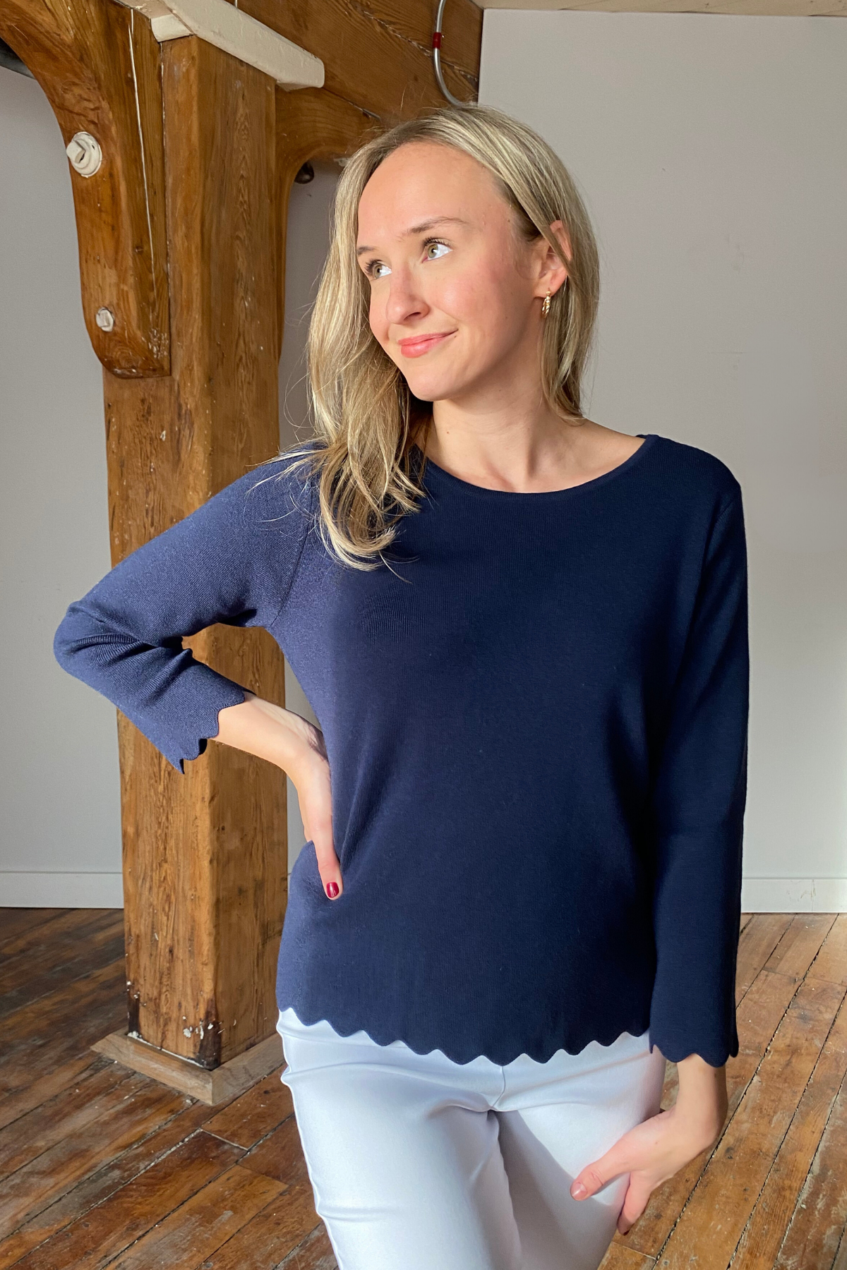 Woman in navy scallop hem pullover